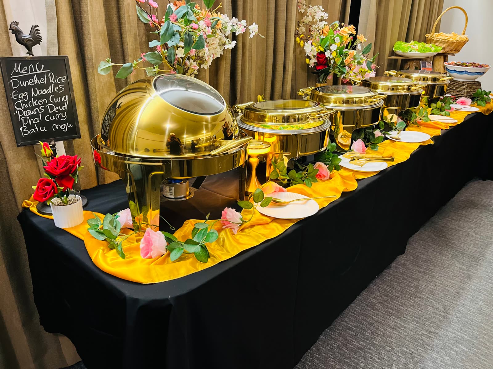Full gold chafing dish buffet line with Sri Lankan menu board